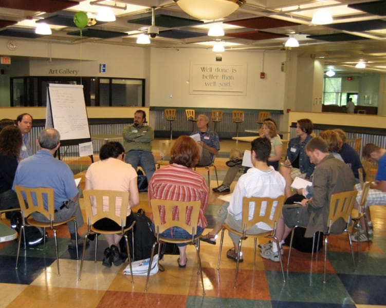 People seated in a circle for a meeting