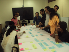 Team collaborating on project with sticky notes.